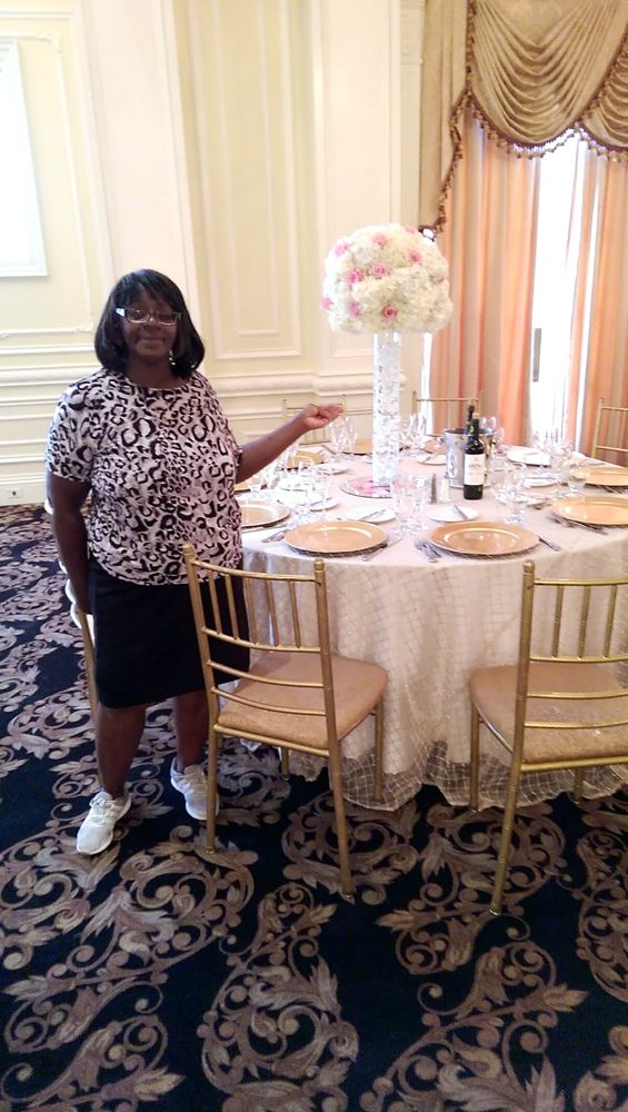 Patricia with a finished centerpiece at a reception