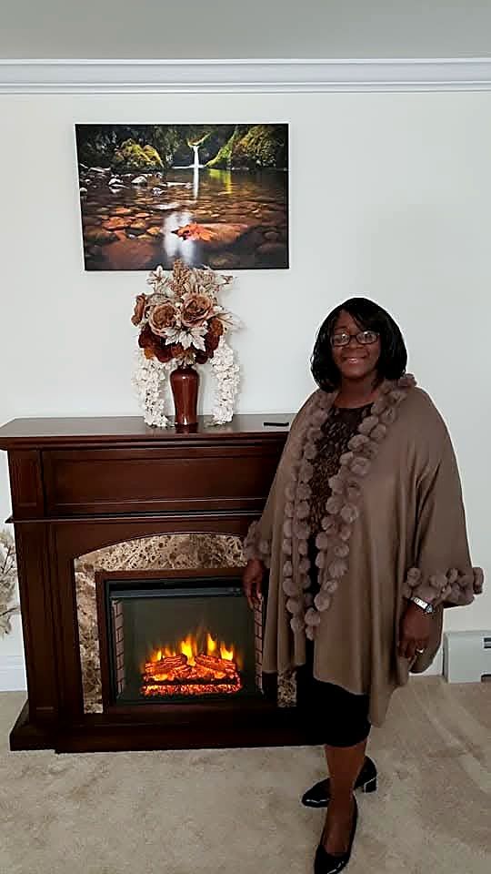 Patricia beside one of her floral arrangements
